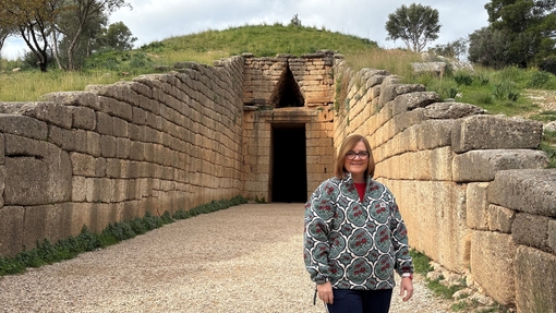 Clare Manning on site with Greek ruins in background