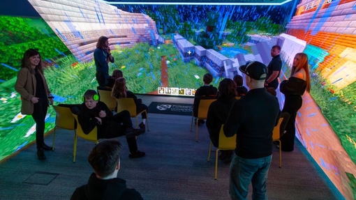Pupils in a multi-coloured immersive room.