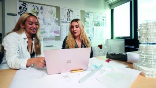 One student showing another something on their laptop