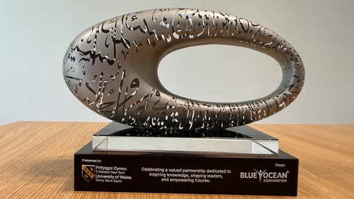 Close up of gift presented to UWTSD by Blue Ocean and included logos of both organisation