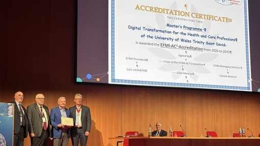 Philip Scott from UWTSD on stage at the conference in Genoa being presented with a certificate