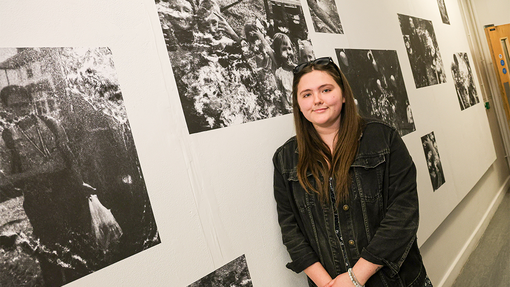 Exhibition Gallery student standing by work 