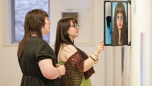 Exhibition Gallery student standing by work 