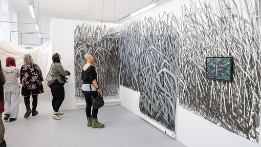 student in front of art work 