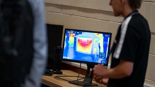 A lecturer demonstrating heat technology.