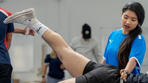 Student working in an injury clinic helping client