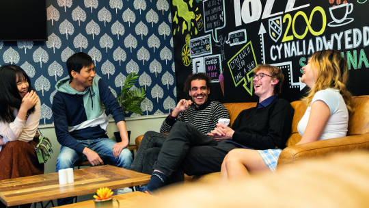 students sitting around coffee table in Lampeter