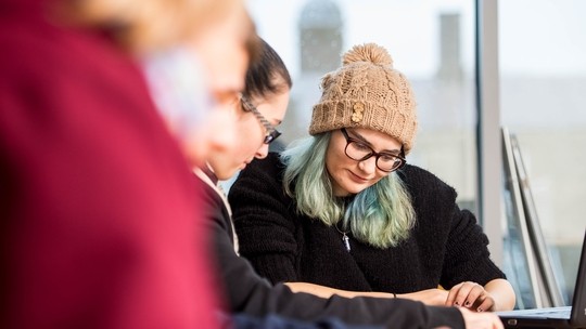 Students collaborating at a desk