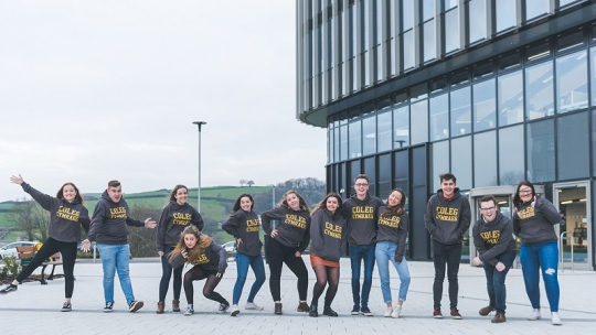 Group of students standing in a line and posing for a photo