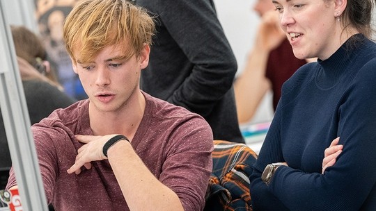 Student  in discussion with teacher