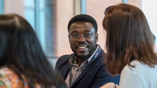 A man talking with his classmate