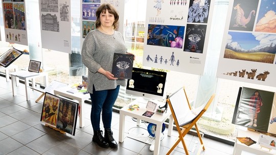 Nia at the art show with her work