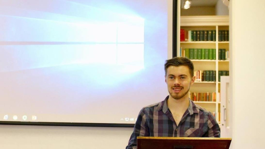 Image of Troy Wilkinson at a lectern