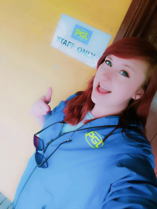 woman taking selfie with 'PGL' written on her shirt