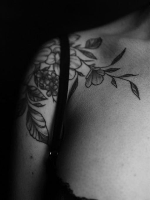 black and white image of a tattoo on a shoulder
