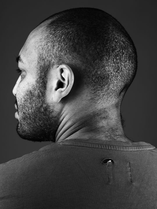 black and white portrait of a male with his back to the camera