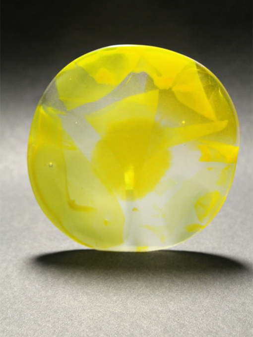 glass circle with yellow running though it