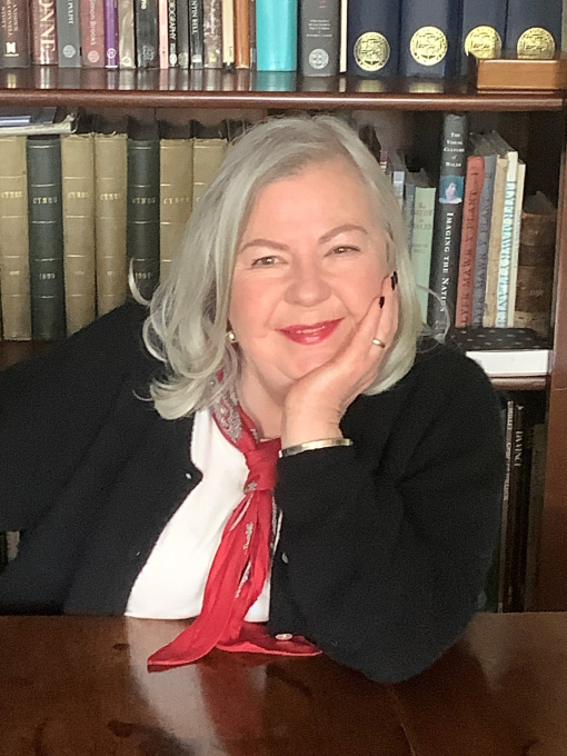 Ruth Richards with book shelf in background
