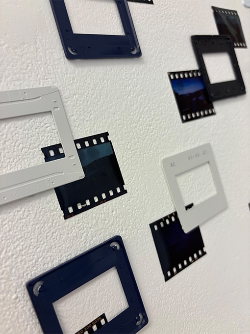 white wall with camera film and frames
