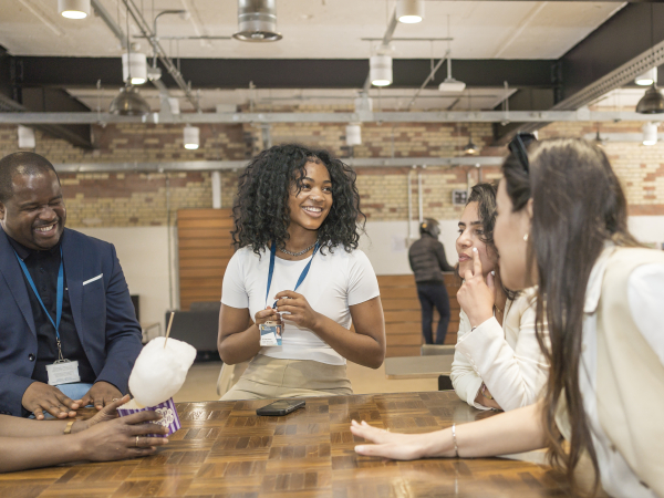 students around a table in London campus