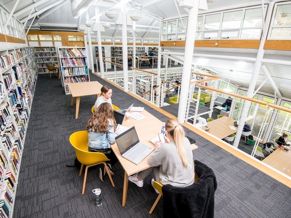 Students sitting in the Carmarthen library 