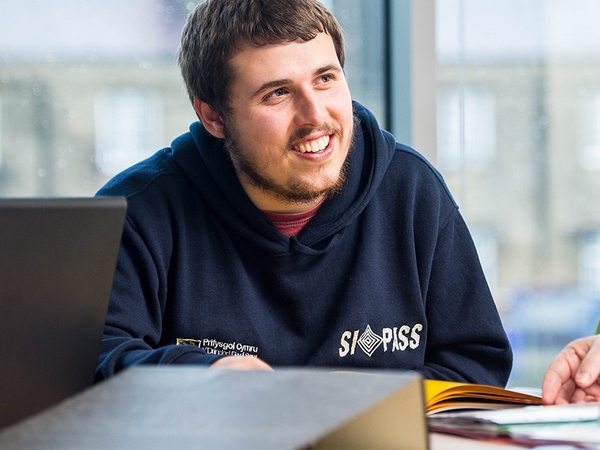 Student smiling and facing to the right