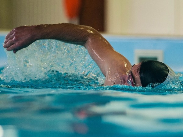 Person swimming in a pool