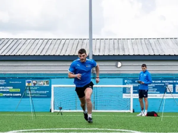 students running on artificial grass
