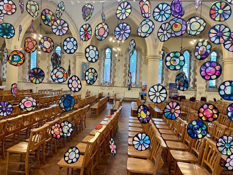 Multi coloured collages hanging in the church