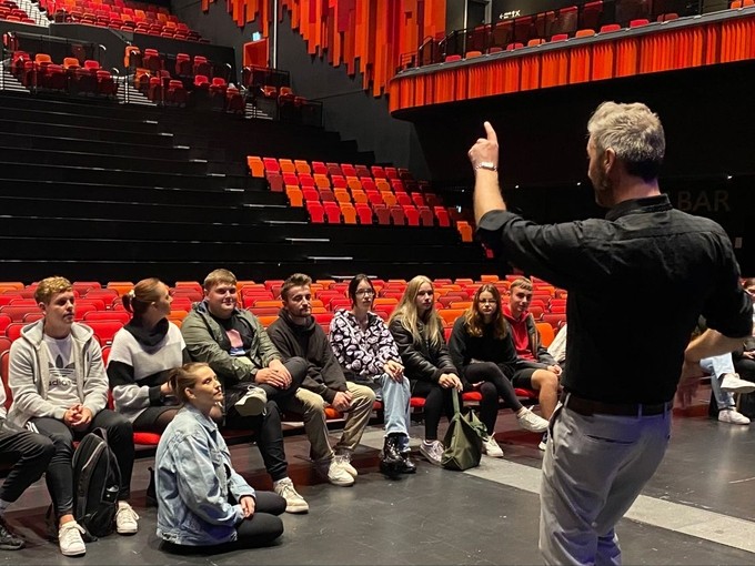 Man facing audience of young people