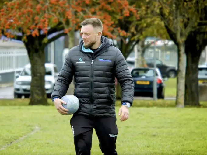 Man holding rugby ball