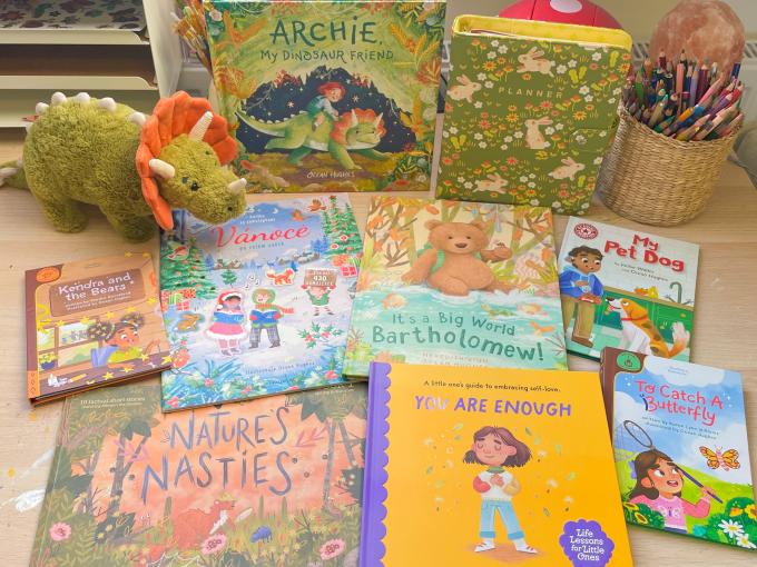 A table with a number of children's books spread out over it