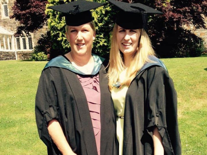 two women graduating in their caps and gowns