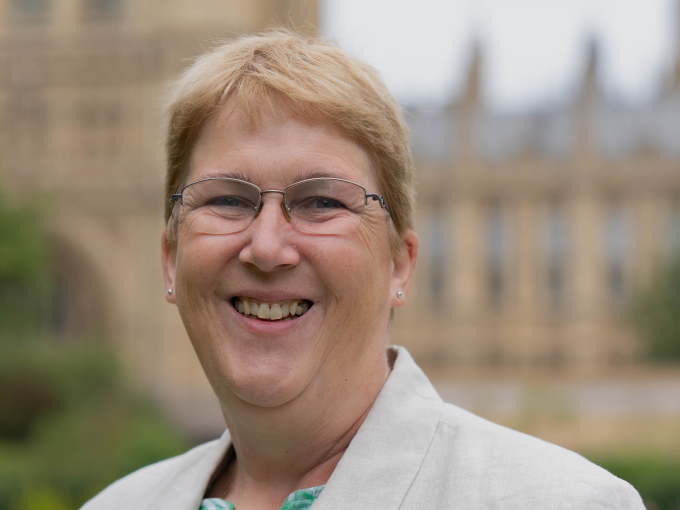 Woman standing in front of Houses of Parliament