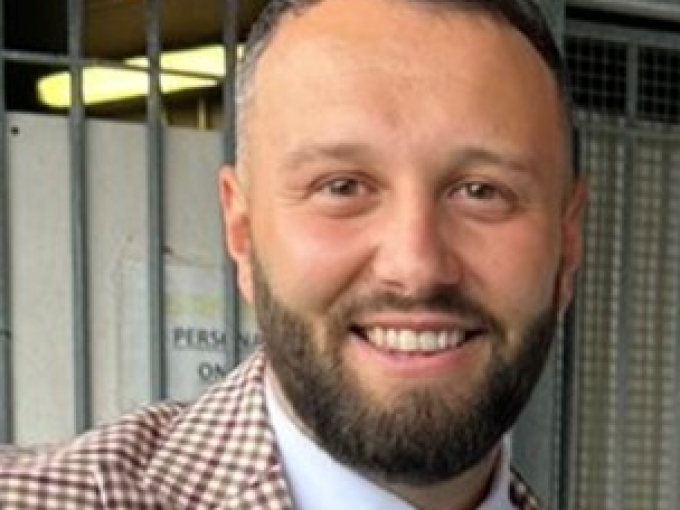 Man in suit and tie smiling at camera