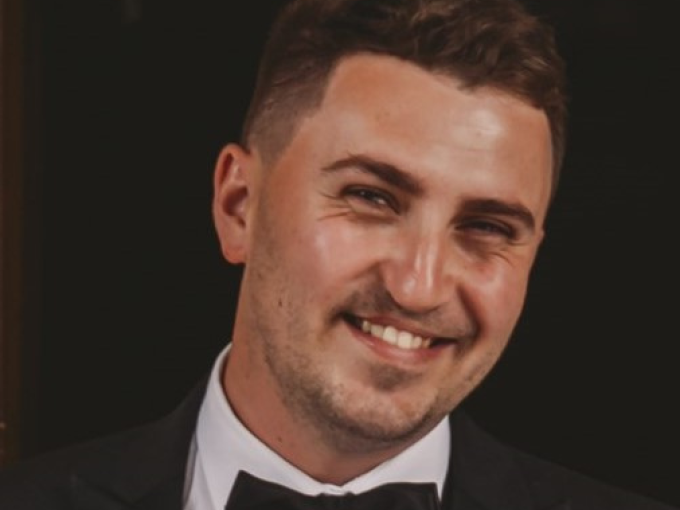 Man in bow tie smiling at camera