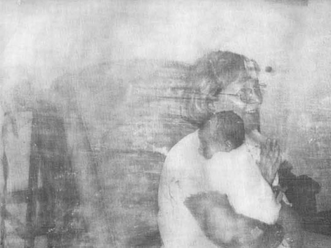 black and white image of a lady holding a baby