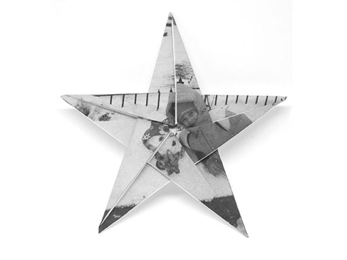 black and white image of a star shape with and image of a girl in snow