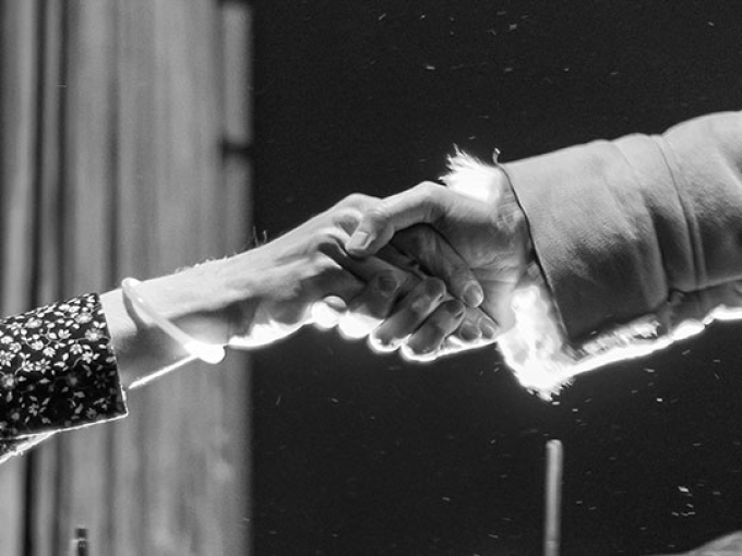 black and white image of two hand holding