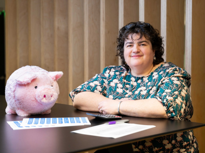 finance officer posing for picture with the piggy bank