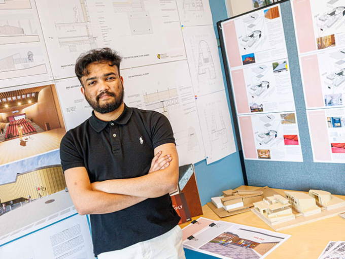 Moynul Ali standing in front of Architecture display