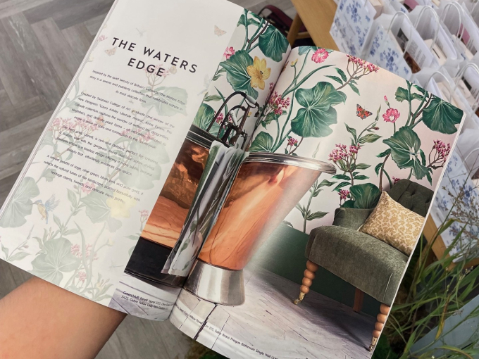 A person holding a magazine featuring Anna Eynon's work
