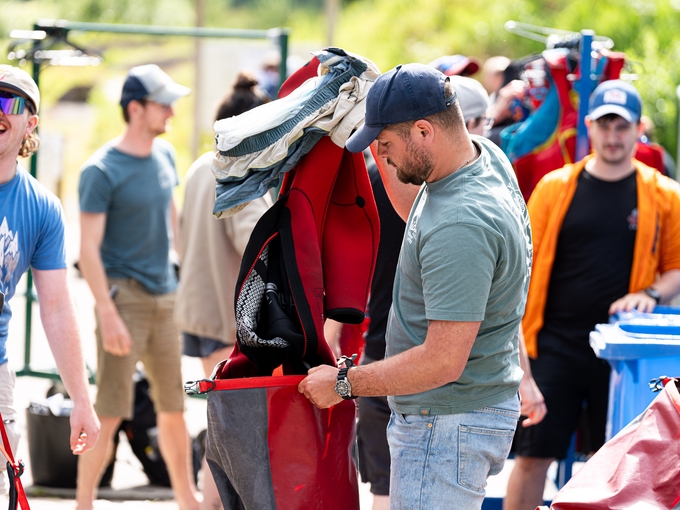 students outside holding wet suites