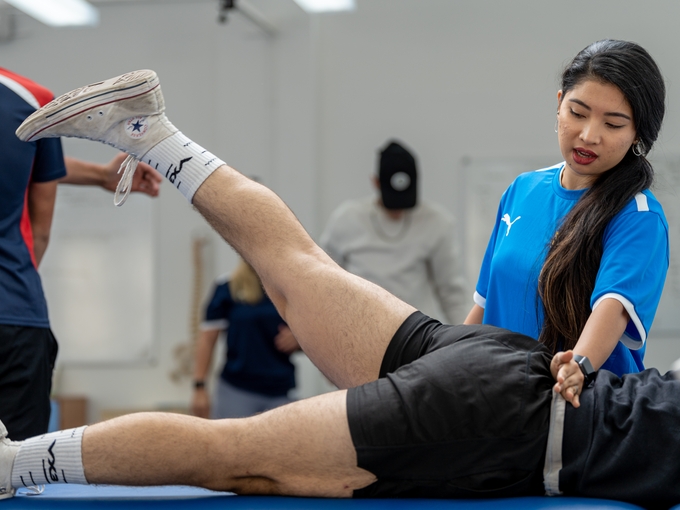 student in sports centre with client