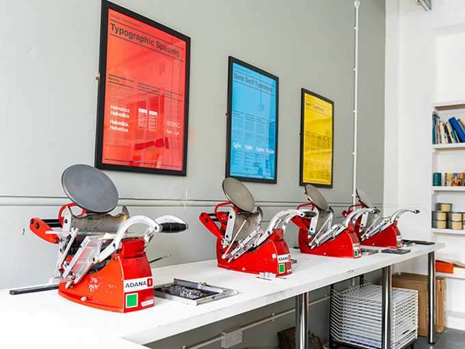 letter press machines with work on wall