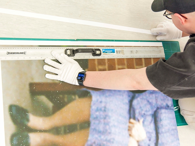 student mounting art to a board