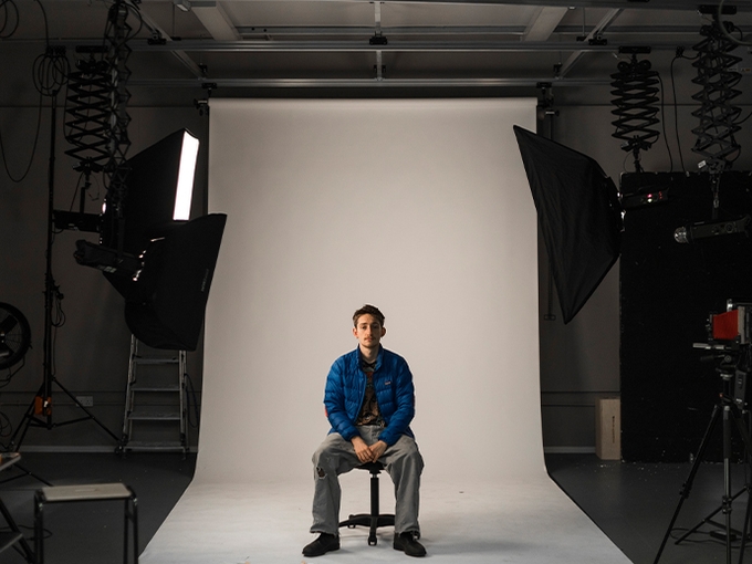 photography studio with a student sitting on a chair