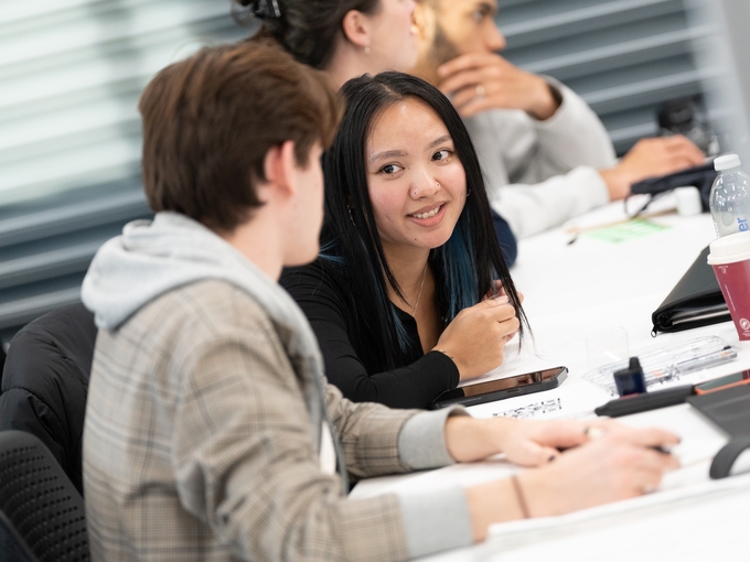 Two students chatting while in class
