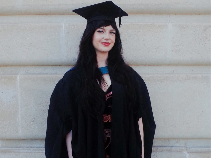 Woman in cap and gown graduating
