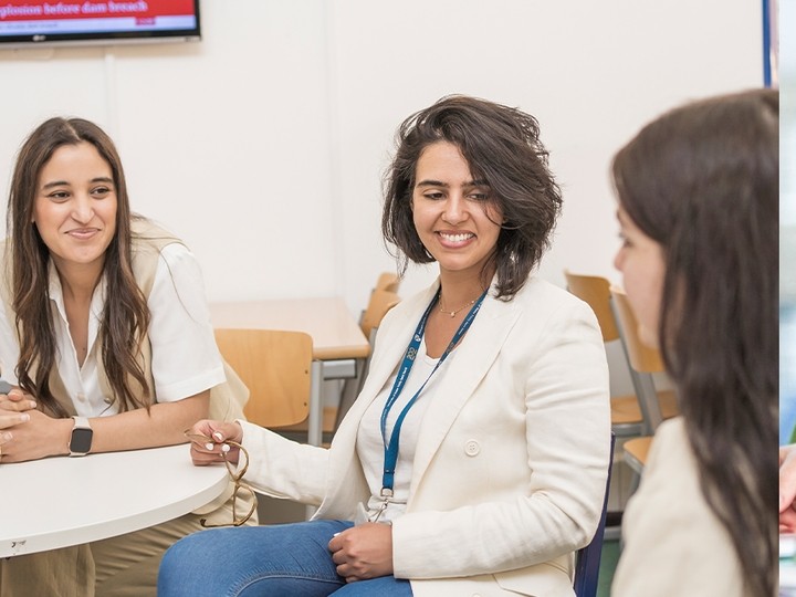 Three staff members having a discussion 